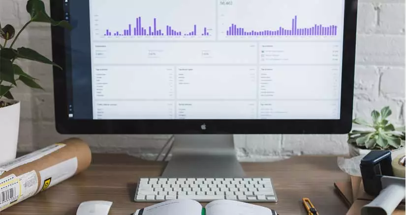 A person looking at Google Analytics page on a MacBook Air